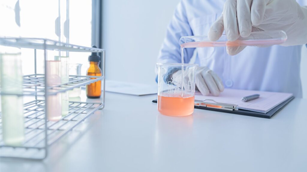 scientist pouring solution into jar