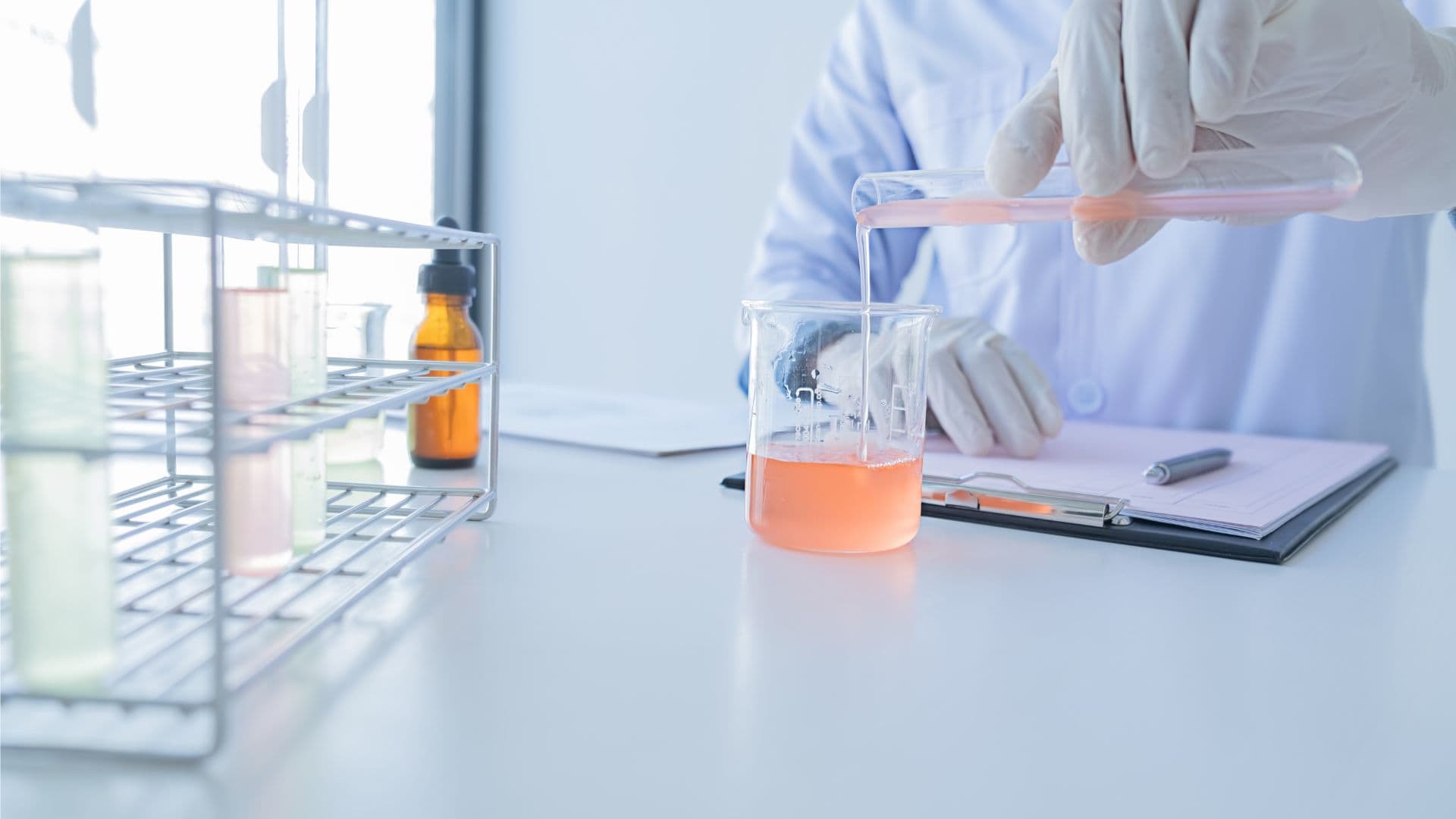 scientist pouring solution into jar