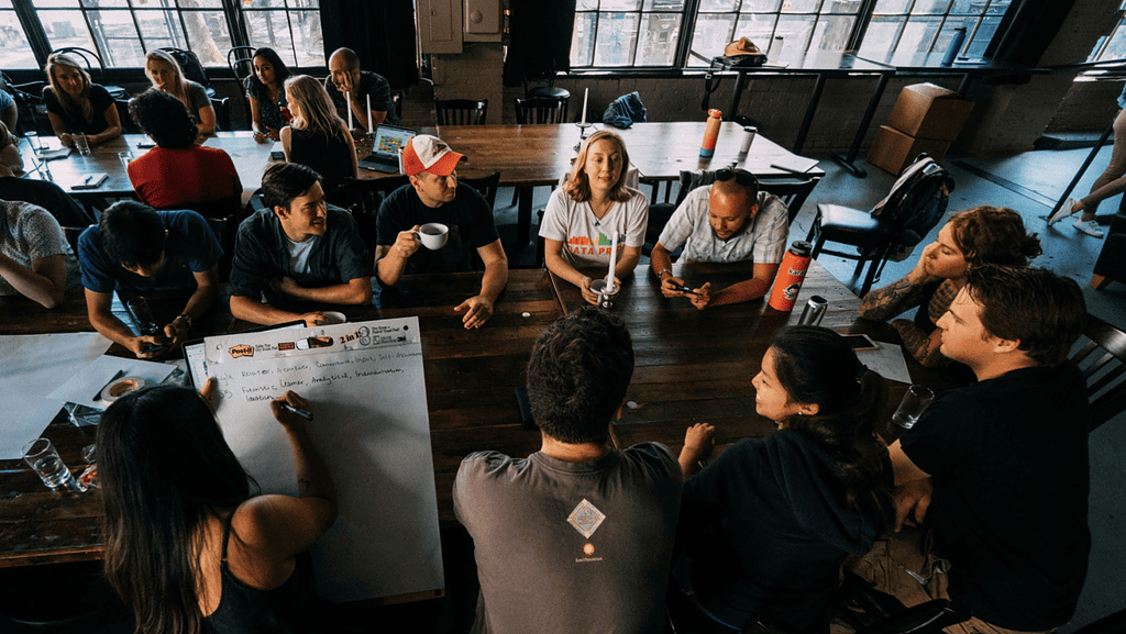 A Karat team sitting a long dining table for a brainstorm session